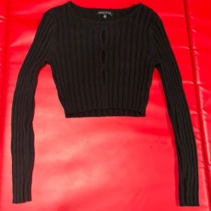 Small, Black Sweater with openings in front middle.